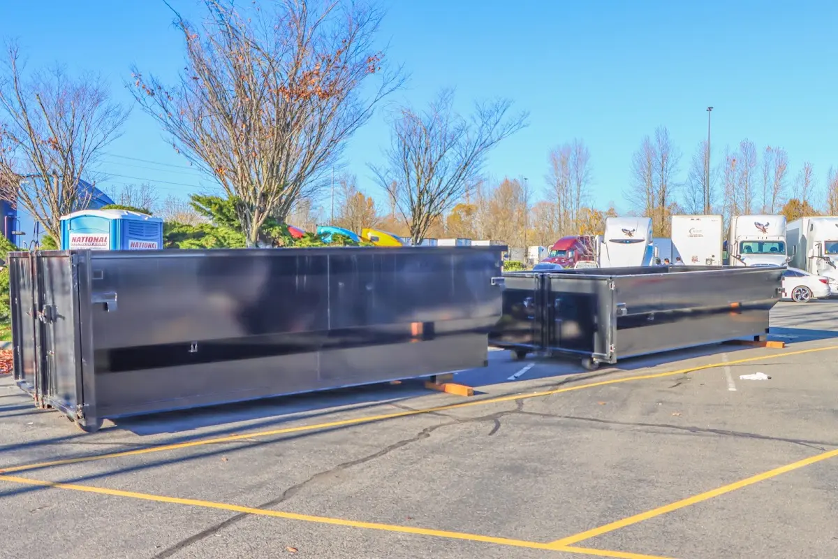 Professional dumpster rental service with roll-off container on residential driveway in Traverse City